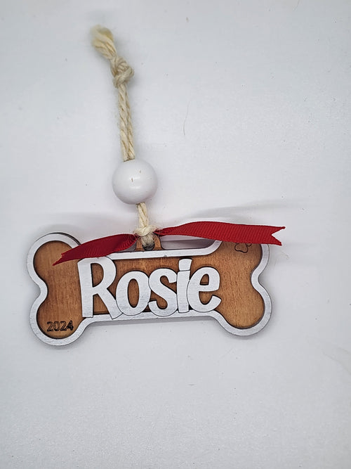 Personalized laser-engraved dog bone Christmas ornament in two-layer wood – custom pet name with optional year and memorial wings holiday keepsake