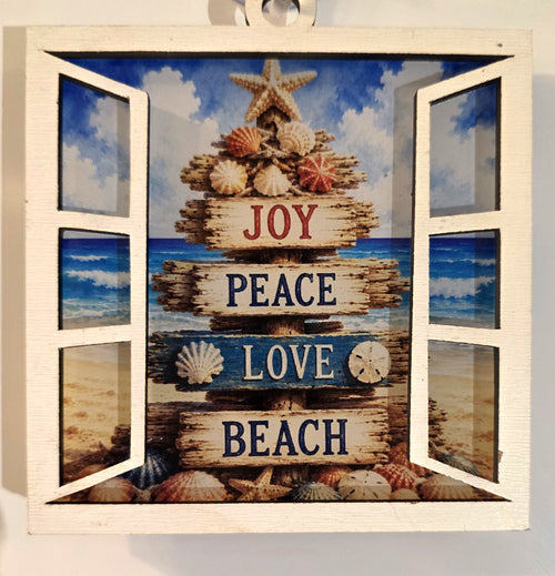 "3.4" acrylic beach Christmas suncatcher in white open window frame featuring a driftwood sign post with Joy, Peace, Love, Beach, seashells, and starfish on a coastal ocean background – by Illuminated Engraving"